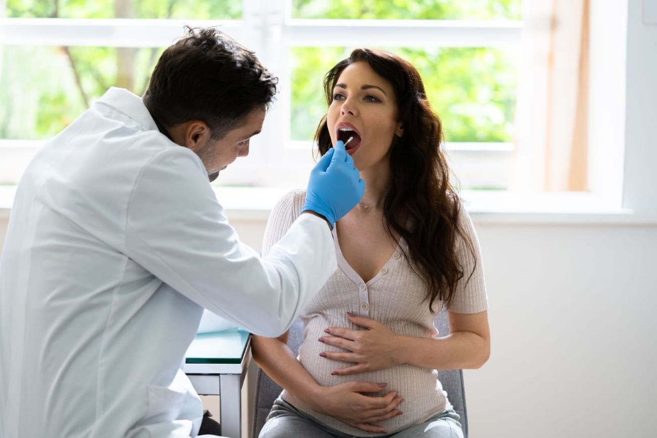 Close-up of a woman undergoing DNA testing with a mouth swab